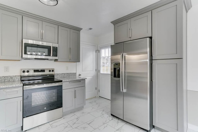 kitchen featuring marble finish floor, stainless steel appliances, gray cabinets, and visible vents