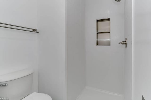 bathroom with toilet and walk in shower