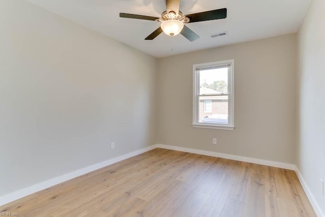 empty room featuring baseboards, visible vents, and light wood-style floors