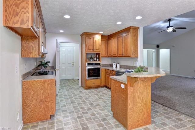 kitchen with oven, brown cabinets, under cabinet range hood, a kitchen breakfast bar, and a peninsula