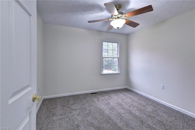 spare room featuring baseboards, a textured ceiling, and carpet flooring