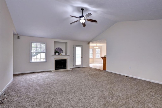 unfurnished living room with lofted ceiling, carpet floors, a fireplace, baseboards, and ceiling fan