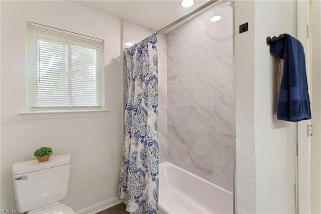 bathroom featuring toilet and shower / bathtub combination with curtain