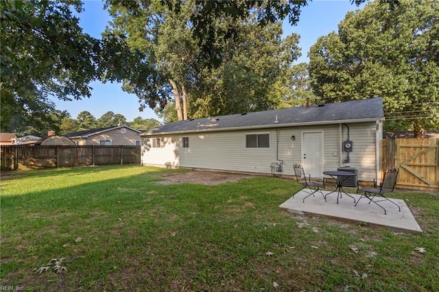 back of house featuring a yard, a fenced backyard, and a patio