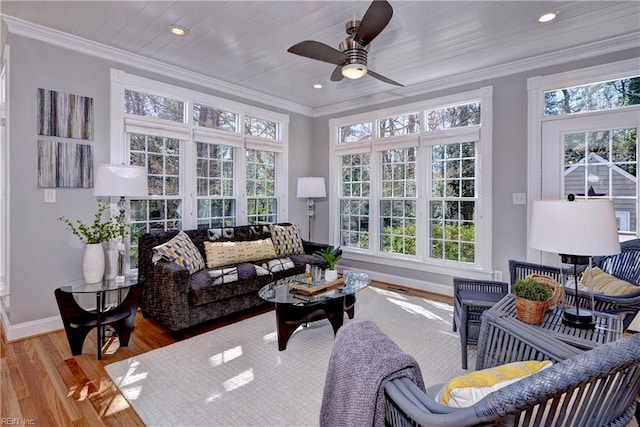 sunroom with a healthy amount of sunlight and ceiling fan