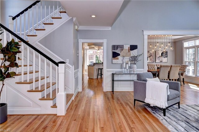 interior space with recessed lighting, light wood-style flooring, stairs, and ornamental molding