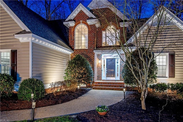 property entrance featuring brick siding