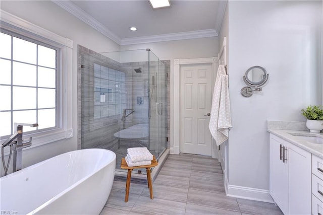 bathroom with vanity, crown molding, baseboards, and a stall shower