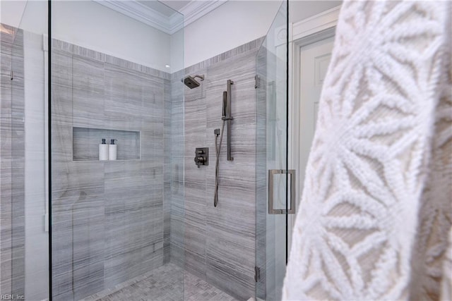 full bathroom featuring a stall shower and crown molding