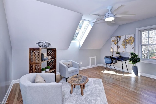 sitting room with baseboards, wood finished floors, a ceiling fan, and vaulted ceiling