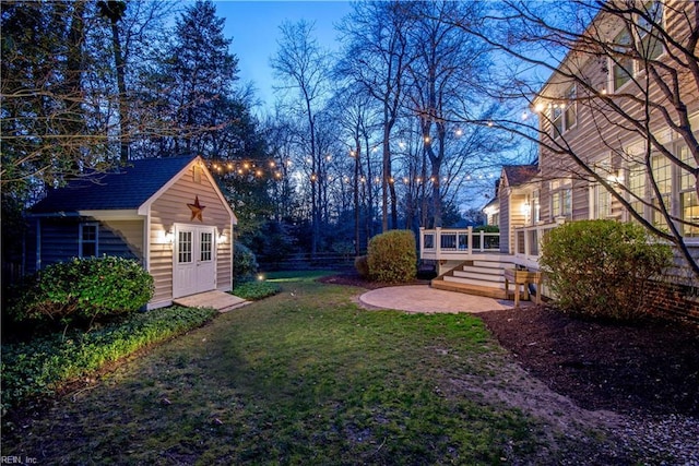 view of yard featuring a patio, an outbuilding, and a wooden deck