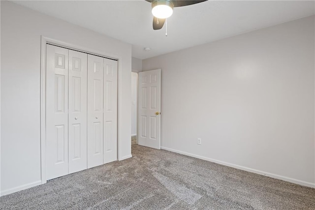 unfurnished bedroom with a closet, carpet, a ceiling fan, and baseboards