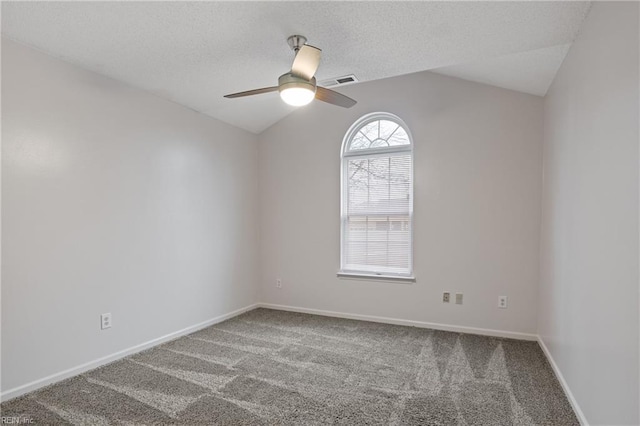 carpeted empty room with baseboards, visible vents, a ceiling fan, lofted ceiling, and a textured ceiling