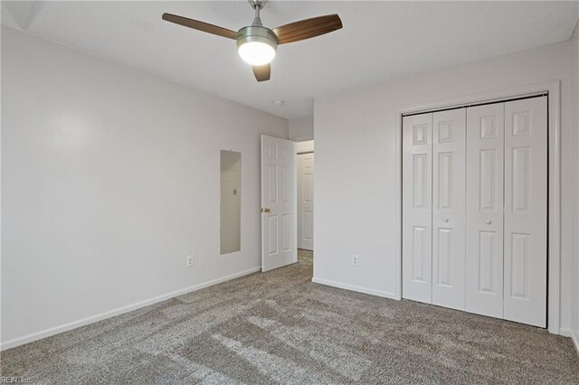 unfurnished bedroom with ceiling fan, a closet, carpet flooring, and baseboards