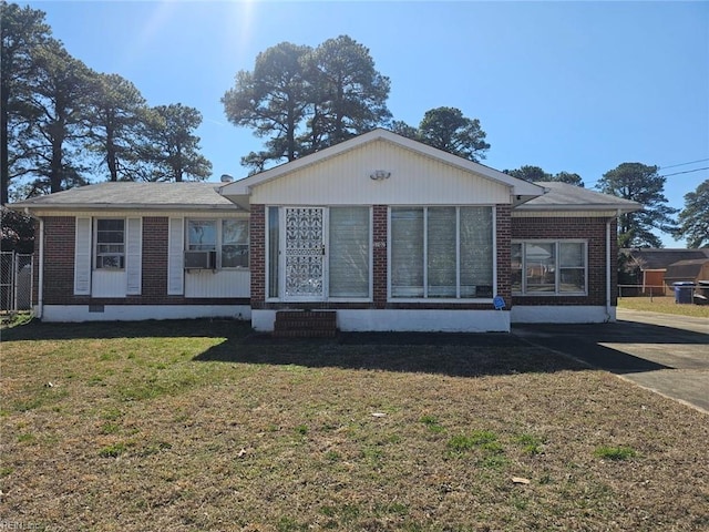 single story home featuring a front lawn, cooling unit, brick siding, and crawl space