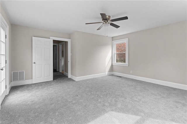 unfurnished bedroom featuring ceiling fan, carpet floors, visible vents, and baseboards