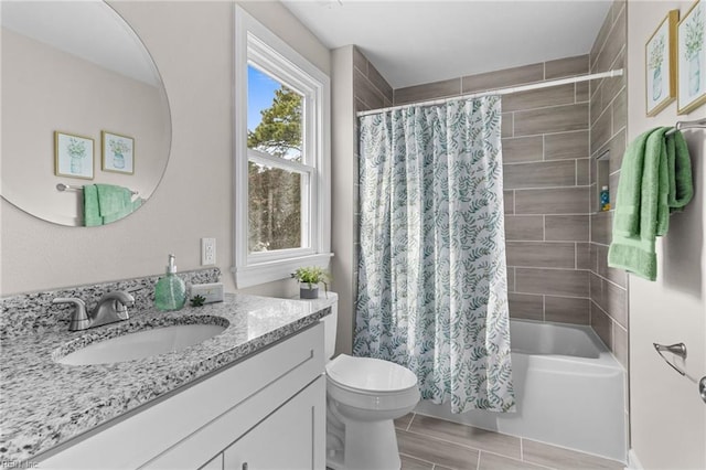 full bath with toilet, shower / bath combo with shower curtain, and vanity