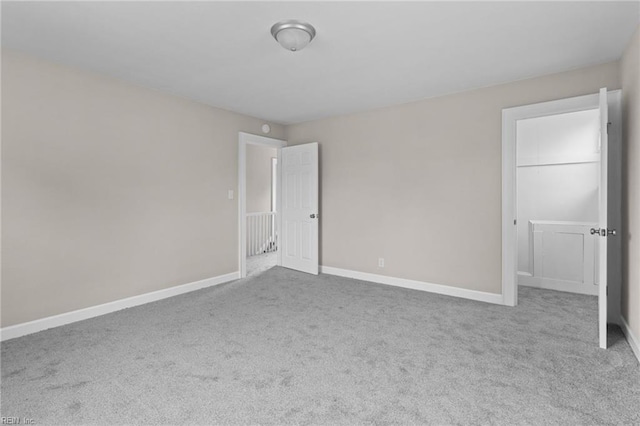 unfurnished bedroom with baseboards and carpet flooring