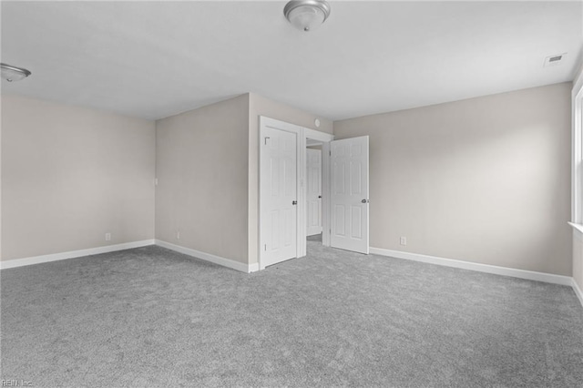 interior space with carpet, visible vents, and baseboards