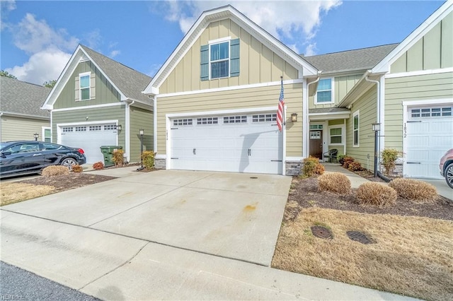 craftsman-style house with driveway, an attached garage, and board and batten siding