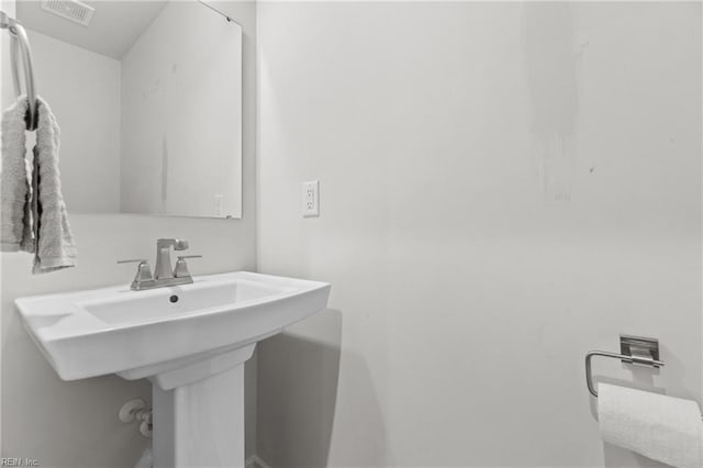 bathroom featuring visible vents and a sink