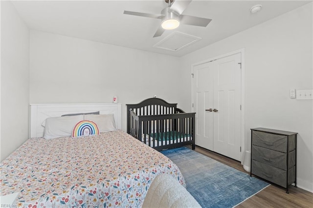 bedroom featuring attic access, ceiling fan, and wood finished floors