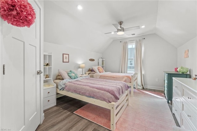 bedroom featuring lofted ceiling, ceiling fan, wood finished floors, visible vents, and baseboards