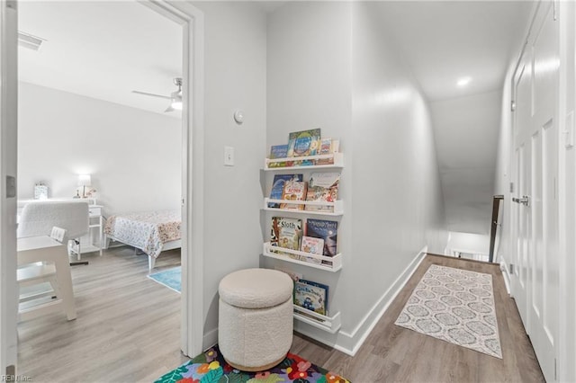 hall featuring baseboards and wood finished floors