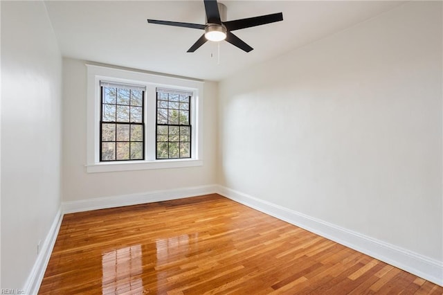 unfurnished room with light wood-style floors, ceiling fan, and baseboards