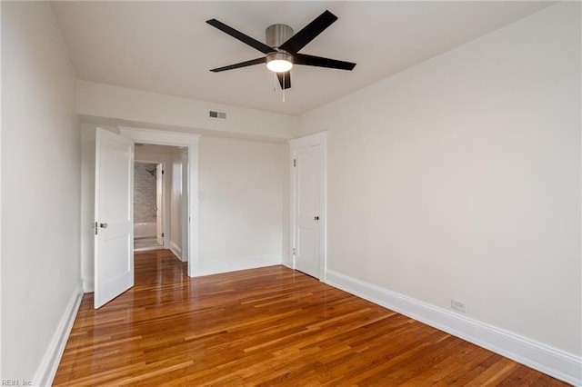 unfurnished room with light wood-type flooring, baseboards, and visible vents