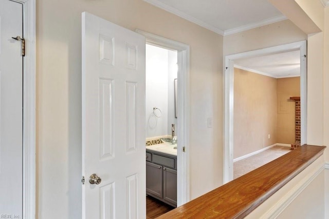 bathroom with ornamental molding, vanity, and baseboards