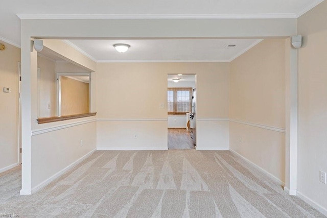 unfurnished room with ornamental molding, carpet, and baseboards