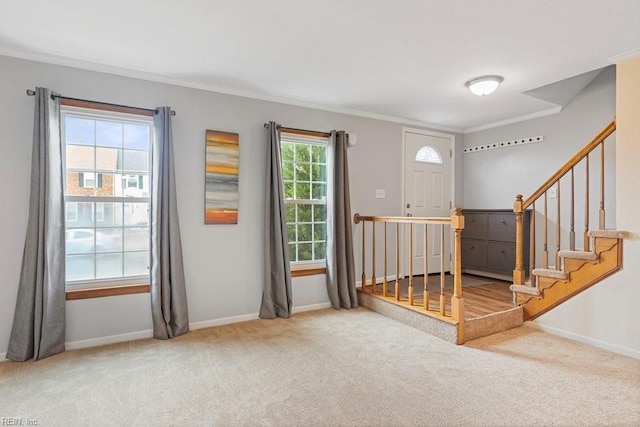 interior space featuring ornamental molding, carpet, stairway, and baseboards