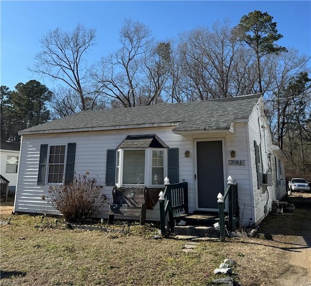 view of front of property featuring roof with shingles