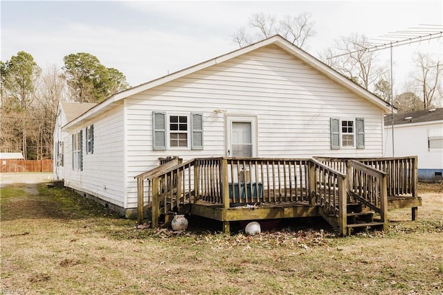 back of house with a deck