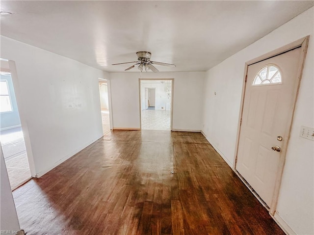 entrance foyer with a ceiling fan, baseboards, and wood finished floors