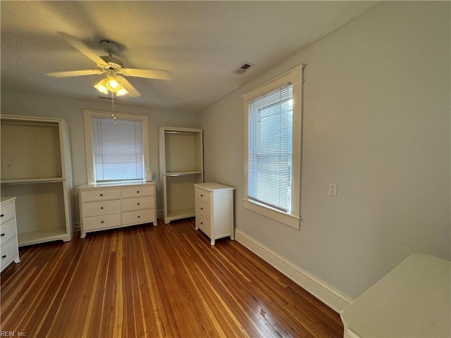 unfurnished bedroom with ceiling fan, hardwood / wood-style floors, visible vents, and baseboards