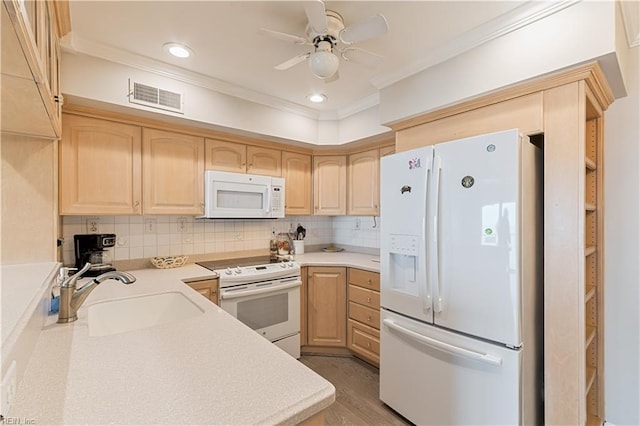 kitchen with white appliances, visible vents, a sink, and light brown cabinetry