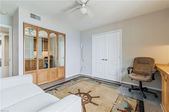 interior space featuring a ceiling fan, visible vents, and baseboards