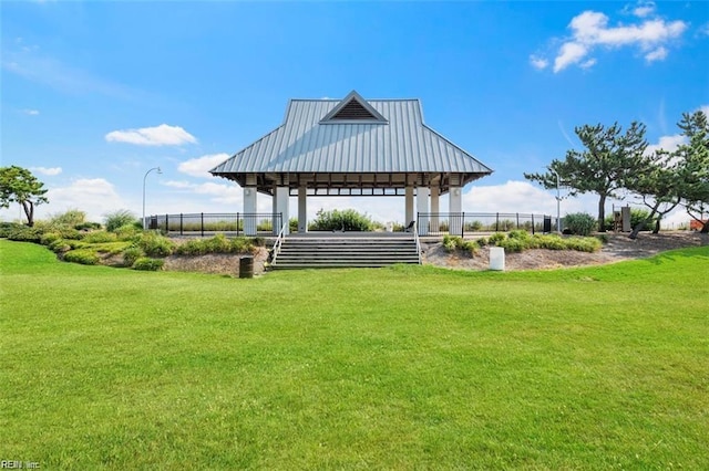 view of property's community featuring a gazebo, fence, and a yard