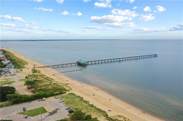 birds eye view of property with a water view and a beach view