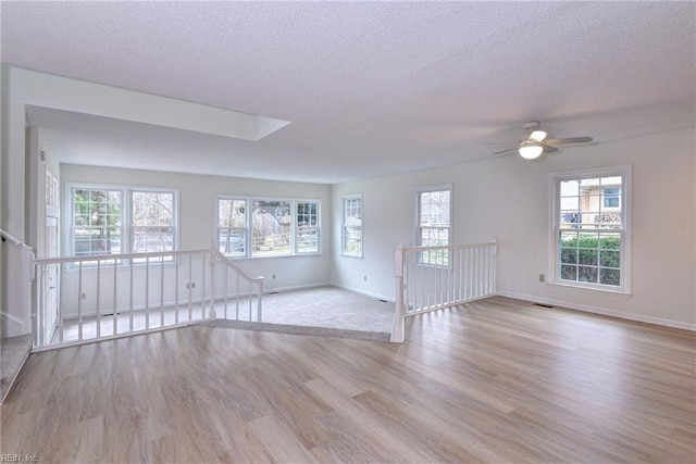 601 Windemere Rd, Newport News, VA 23602 - unfurnished living room with ceiling fan, a textured ceiling, baseboards, and wood finished floors
