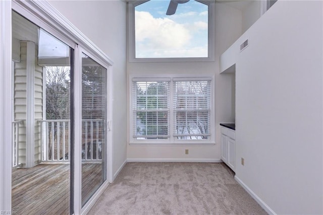 unfurnished sunroom with ceiling fan and visible vents