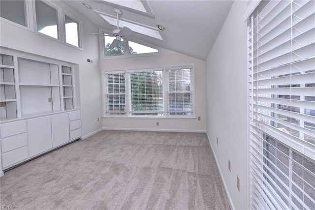 interior space with light carpet, ceiling fan, high vaulted ceiling, and baseboards