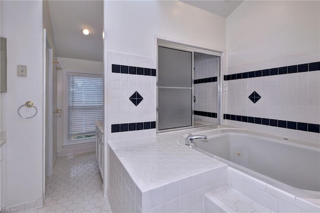 full bath featuring a tub with jets and tile patterned flooring