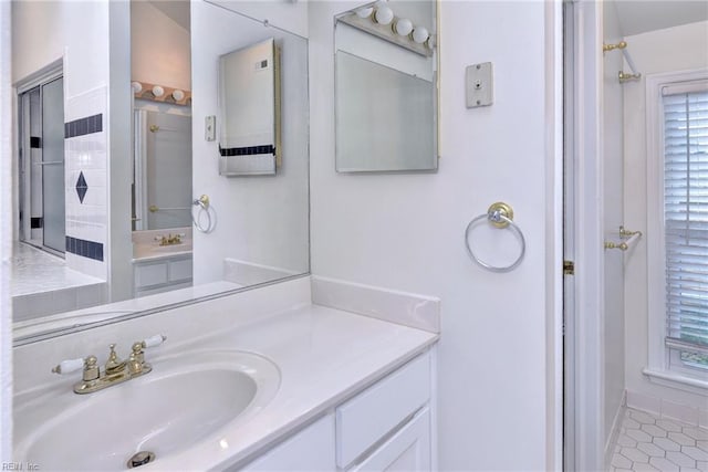 full bath with tile patterned flooring, a shower, and vanity