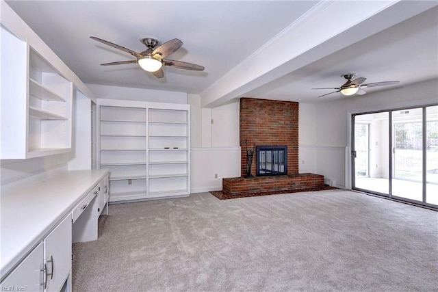 unfurnished living room featuring a ceiling fan, light carpet, and a fireplace