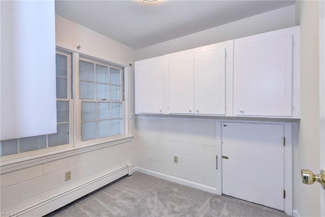 unfurnished room featuring carpet and a baseboard radiator