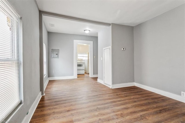 empty room featuring wood finished floors and baseboards