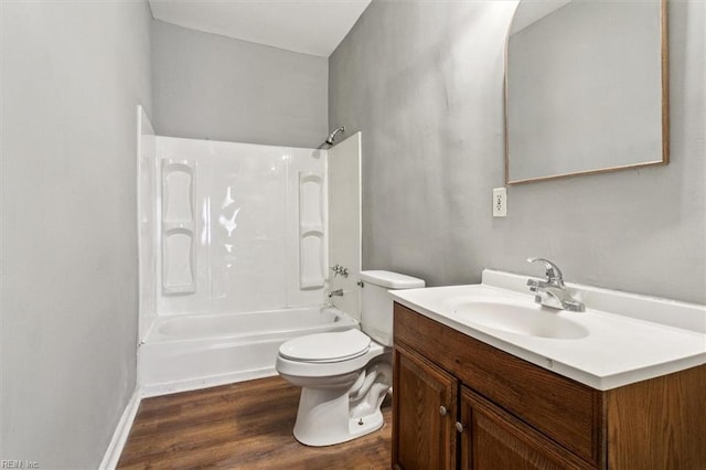 bathroom with vanity, tub / shower combination, wood finished floors, and toilet